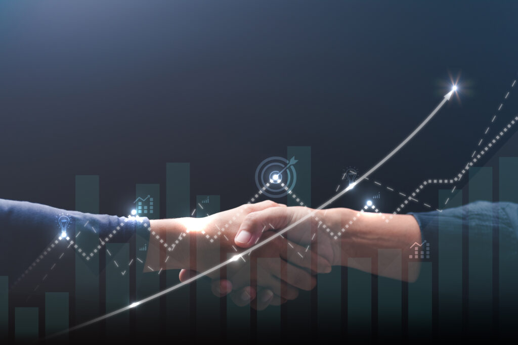 ビジネスパートナーの握手と上昇するグラフによる業績向上のイメージ